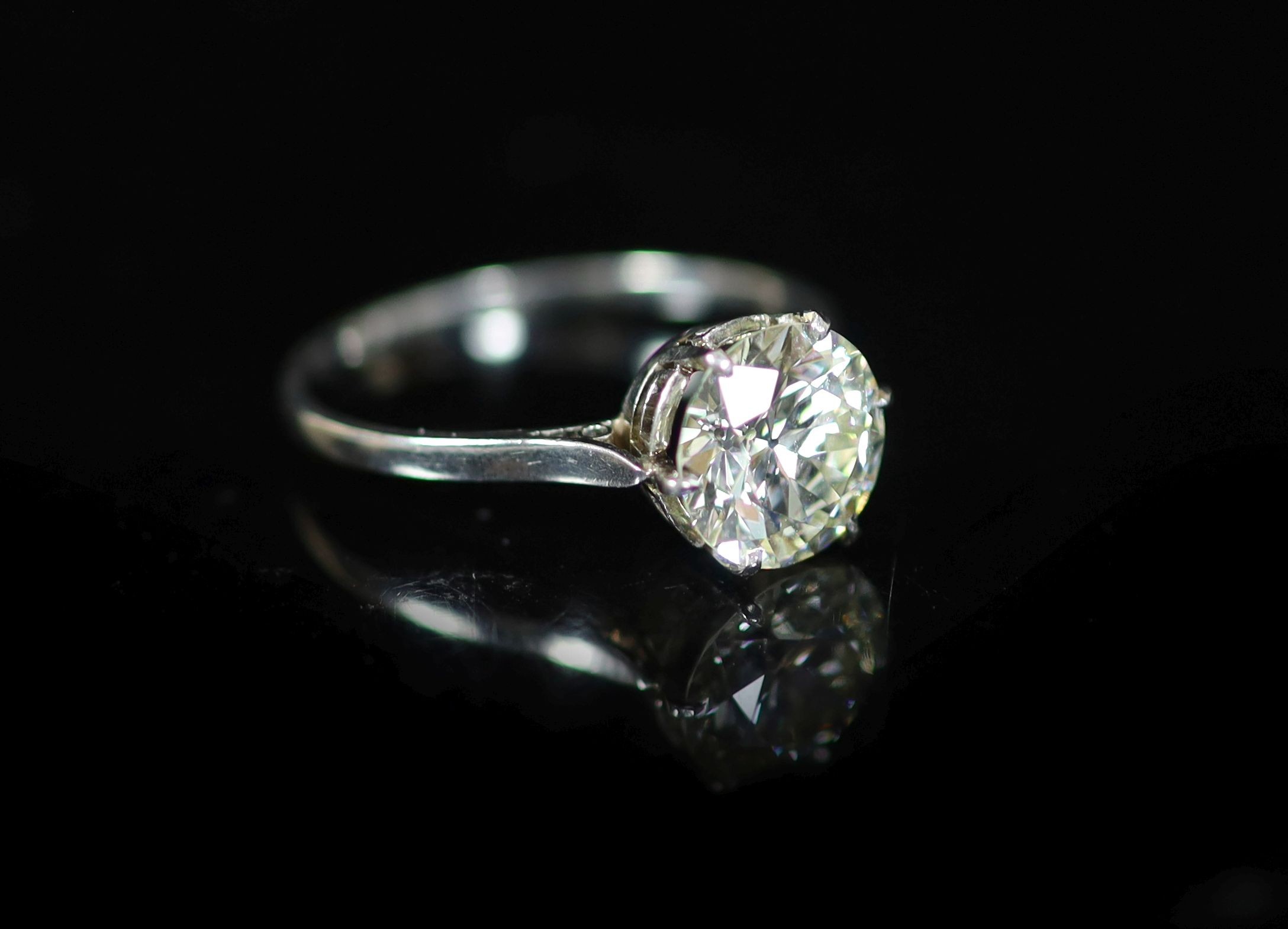 A platinum and solitaire diamond ring